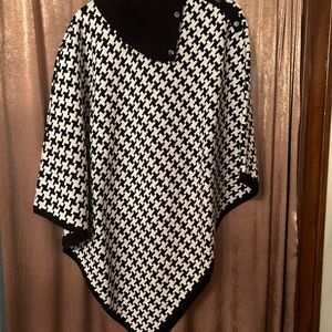 Black/white poncho. Recently dry cleaned. Size is L/XL